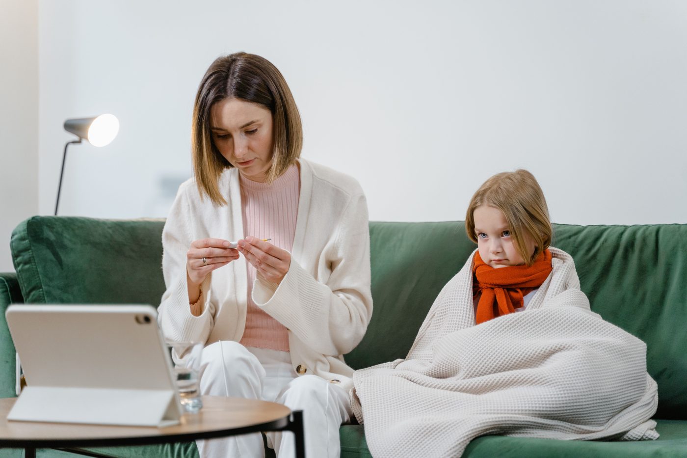 A parent caring for a sick child at home during a virtual Primary Health visit